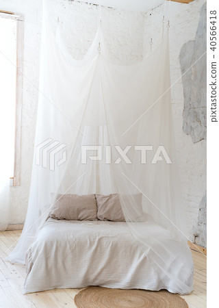 beautiful bedroom with wooden four poster bed 40566418