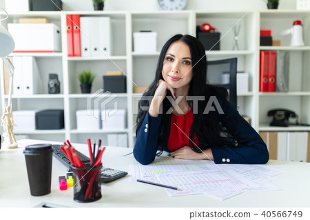 Beautiful young girl working with documents in the office. On the table are papers and a pencil. Beautiful young girl working with documents in the office. On the table are papers and a pencil. 40566749