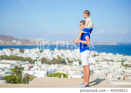 Happy father and little adorable girl in Mykonos during summer greek vacation Happy father and little adorable girl in Mykonos during summer greek vacation 40568652