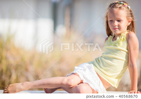Portrait of adorable little girl in yoga outdoor on vacation Portrait of adorable little girl in yoga outdoor on vacation 40568670