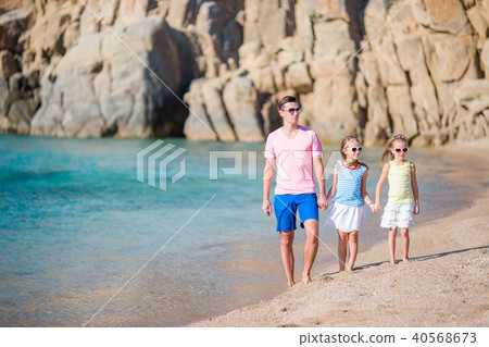 Family of dad and kids on white sandy beach Family of dad and kids on white sandy beach 40568673