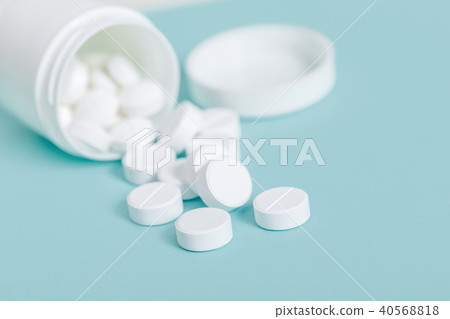 Pills spilling out of pill bottle Pills spilling out of pill bottle 40568818