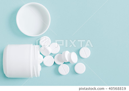 Pills spilling out of pill bottle 40568819