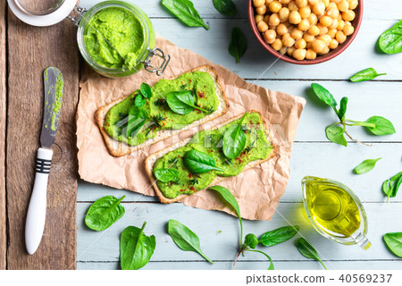 Two crackers with green spinach humus Two crackers with green spinach humus 40569237