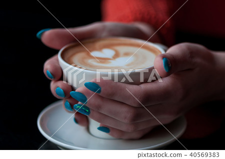 Hands holding a coffee cup with heart shape Hands holding a coffee cup with heart shape 40569383