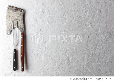 Old rustic axe for meat on a wooden board Old rustic axe for meat on a wooden board 40569396
