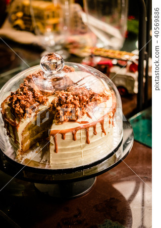 Caramel cake under bell glass dome 40569886