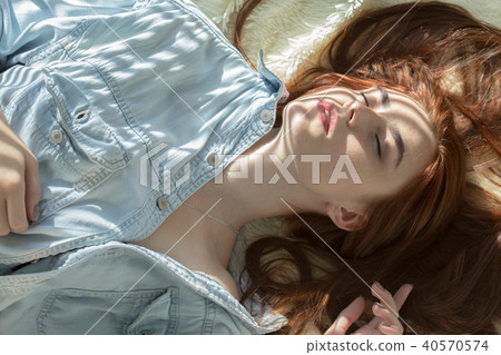 sensual beautiful woman, closed eyes lying in sunlight with blinds shadows sensual beautiful woman, closed eyes lying in sunlight with blinds shadows 40570574