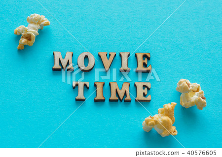 Text "Movie Time" and popcorn on blue background. Text "Movie Time" and popcorn on blue background. 40576605