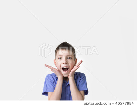 Portrait of smiling teen boy. Happy teenager wearing t-shirt. 40577994