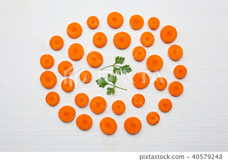 Chopped carrot slices and parsley leaves Chopped carrot slices and parsley leaves 40579248