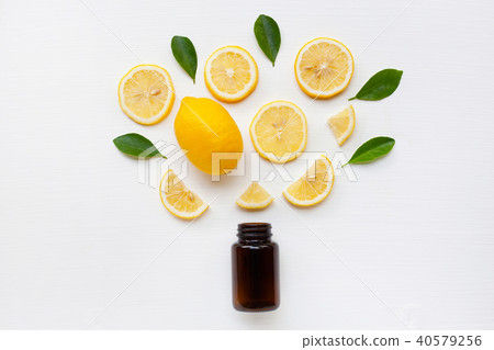 Bottle with lemon and leaves. Bottle with lemon and leaves. 40579256