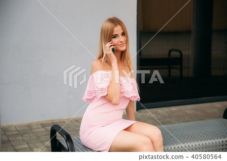 Models walk around the city and use Gadgets. Sunny day. Summer. Models walk around the city and use Gadgets. Sunny day. Summer. 40580564