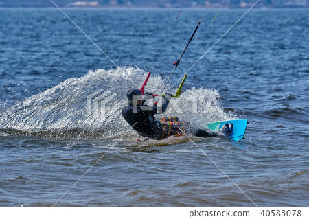 male kiteboarder rides on a board on a large river male kiteboarder rides on a board on a large river 40583078