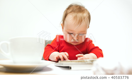 Happy child baby girl toddler sitting with keyboard of computer isolated on a white background Happy child baby girl toddler sitting with keyboard of computer isolated on a white background 40583776