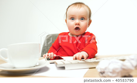 Happy child baby girl toddler sitting with keyboard of computer isolated on a white background 40583790