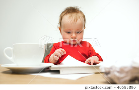 Happy child baby girl toddler sitting with keyboard of computer isolated on a white background 40583890
