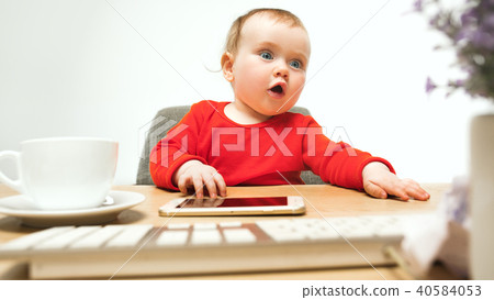 Happy child baby girl toddler sitting with keyboard of computer isolated on a white background 40584053