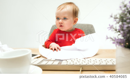 Happy child baby girl toddler sitting with keyboard of computer isolated on a white background 40584085