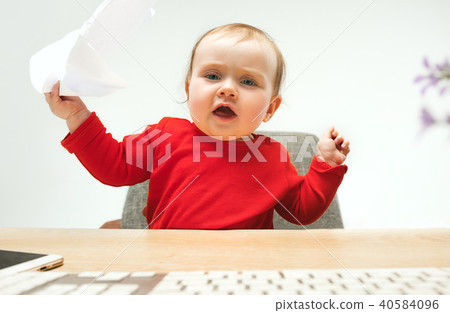 Happy child baby girl toddler sitting with keyboard of computer isolated on a white background 40584096