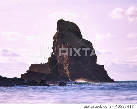 Cloudy evening on rocky shore at sunset. Cloudy evening on rocky shore at sunset. 40585417