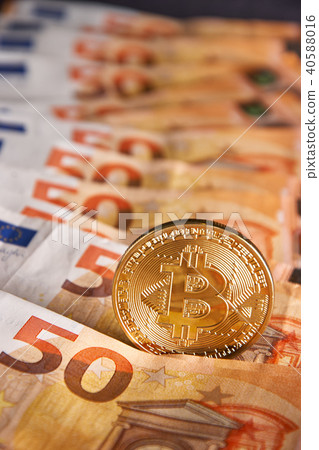 Golden bitcoin on fifty euro banknotes background Golden bitcoin on fifty euro banknotes background 40588016