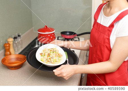 A woman enjoying cooking A woman enjoying cooking 40589390