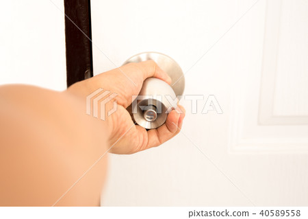 Man hand opening door knob 40589558
