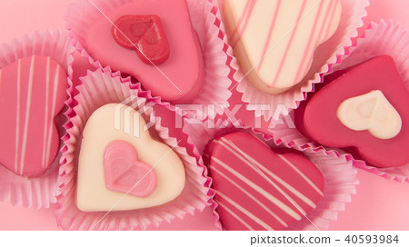 Pink heart shaped petit fours seen from above Pink heart shaped petit fours seen from above 40593984