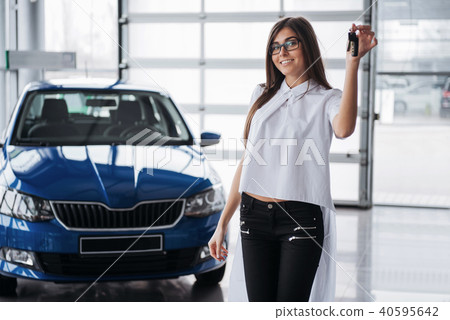 Young happy woman near the car with keys in hand Young happy woman near the car with keys in hand 40595642