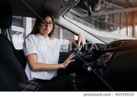 portrait of young beautiful woman sitting in the car 40595659