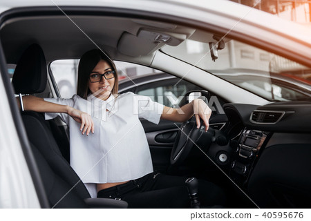 portrait of young beautiful woman sitting in the car portrait of young beautiful woman sitting in the car 40595676