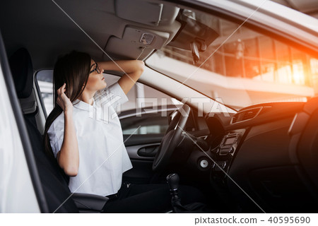 portrait of young beautiful woman sitting in the car portrait of young beautiful woman sitting in the car 40595690
