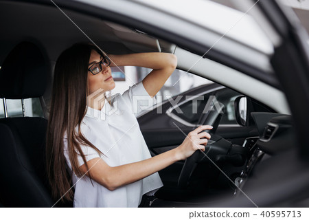 portrait of young beautiful woman sitting in the car 40595713