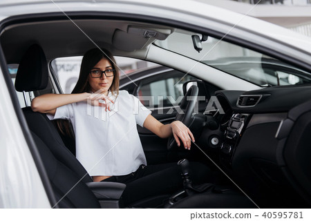 portrait of young beautiful woman sitting in the car 40595781