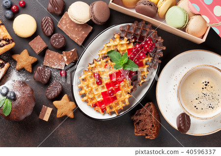 Coffee, sweets and waffles with berries Coffee, sweets and waffles with berries 40596337