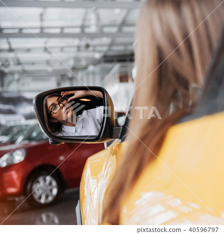 Young woman in her new car smiling Young woman in her new car smiling 40596797