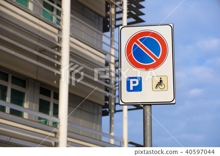 handicapped sign mark parking spot, disabled parking permit sign on pole with convenience store in handicapped sign mark parking spot, disabled parking permit sign on pole with convenience store in 40597044