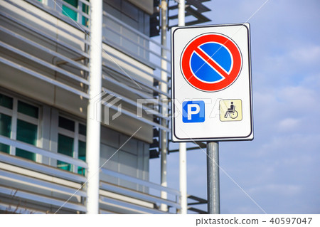 handicapped sign mark parking spot, disabled parking permit sign on pole with convenience store in handicapped sign mark parking spot, disabled parking permit sign on pole with convenience store in 40597047
