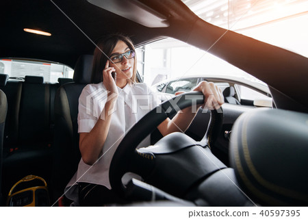 Businesswoman talking on the phone in the car 40597395