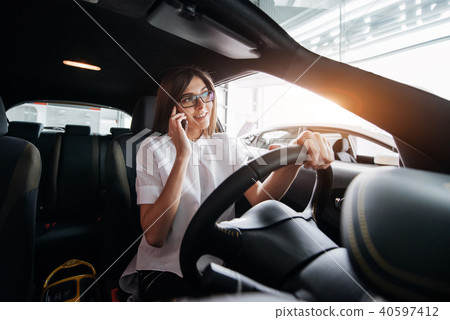 Businesswoman talking on the phone in the car 40597412