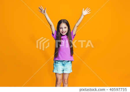 Happy success teen girl celebrating being a winner. Dynamic energetic image of female model 40597735