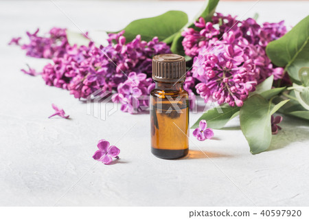 Glass jar with rose water and lilac flower.Closeup 40597920