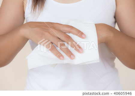 Woman cleaning her hands with a tissue.  40605946