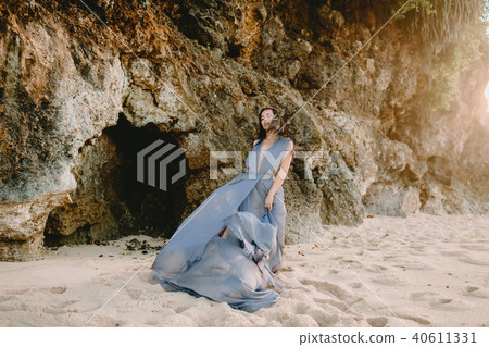 Bride in blue wedding dress in beach at sunset 40611331