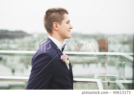 Headshot portrait of young man smiling isolated on outside outdoors background 40613173