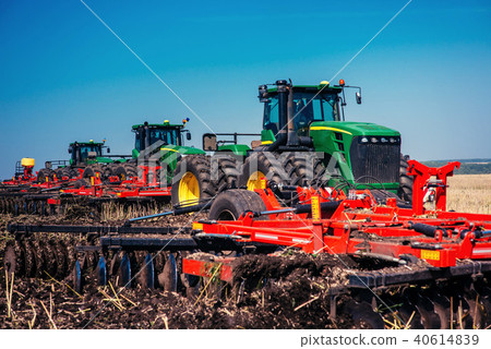 Tractor plowing farm field in preparation for spring planting Tractor plowing farm field in preparation for spring planting 40614839