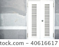Locked white entrance door on painted cement wall 40616617