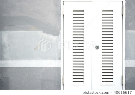 Locked white entrance door on painted cement wall 40616617
