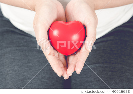 Red heart on pregnant woman hand. Red heart on pregnant woman hand. 40616628